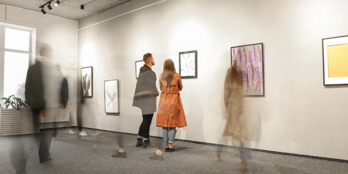 People Viewing Modern Art In Gallery